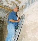 Peter Piccione examining texts in tomb 121 (click to open)