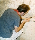 Stephen Rickerby cleaning & examining wall, tomb 121 (click to open)