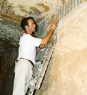 Stephen Rickerby examining paint & plaster in tomb 121 (click to open)